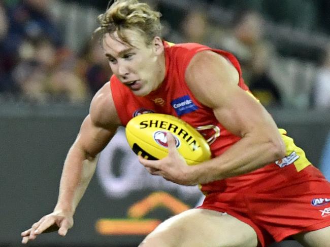 Tom Lynch of the Suns evades Luke Brown of the Crows during the Round 6 AFL match between the Adelaide Crows and the Gold Coast Suns at Adelaide Oval in Adelaide, Saturday, April 28, 2018. (AAP Image/Kelly Barnes) NO ARCHIVING, EDITORIAL USE ONLY