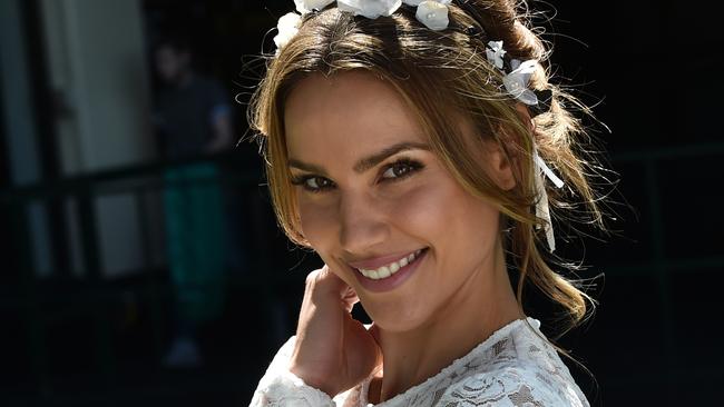 Rachael Finch poses for photos in the mounting yard on Cox Plate Day at Moonee Valley racecourse in Melbourne, Saturday, Oct. 24, 2015. (AAP Image/Julian Smith) NO ARCHIVING