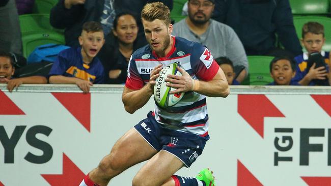 Dom Shipperley of the Rebels scores a try against the Hurricanes at AAMI Park.