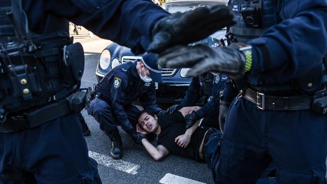 Police officers detain a protester in Sydney on Saturday. Picture: NCA NewsWire/Flavio Brancaleone