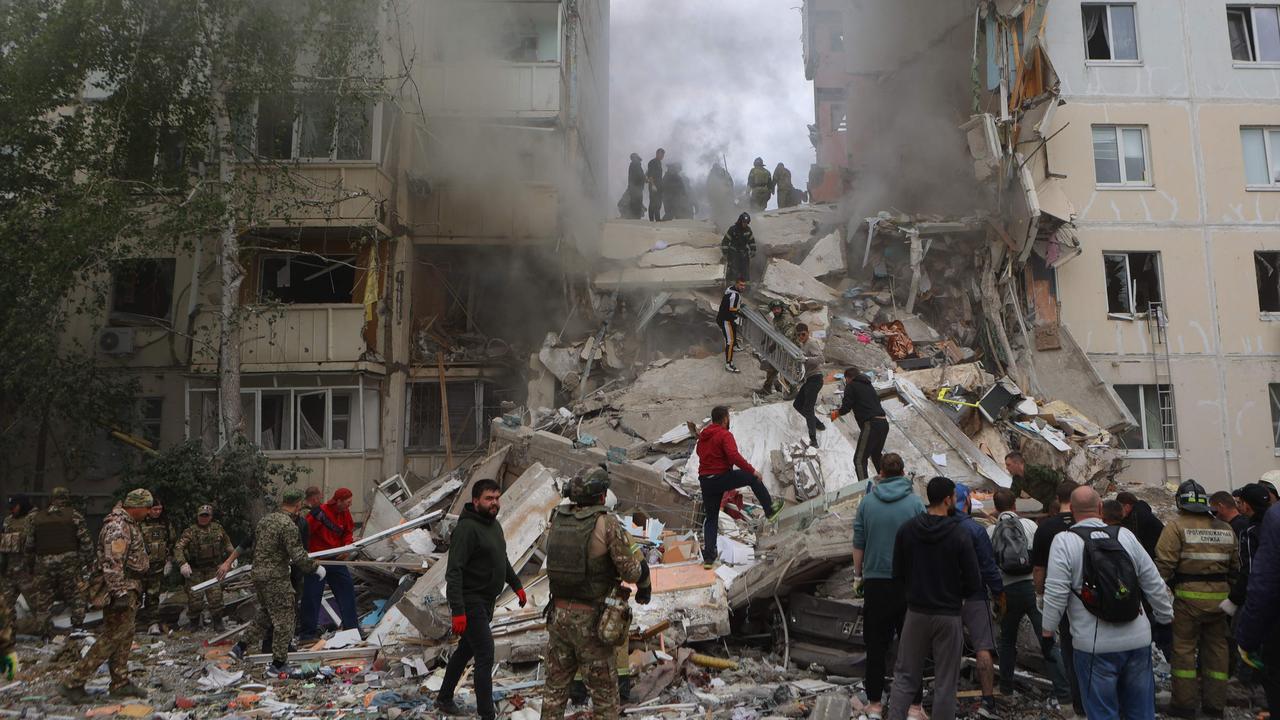 Firefighters and volunteers operate to secure the area on the site of a partially collapsed apartment building which was damaged by a Ukrainian strike in Belgorod. Photo AFP