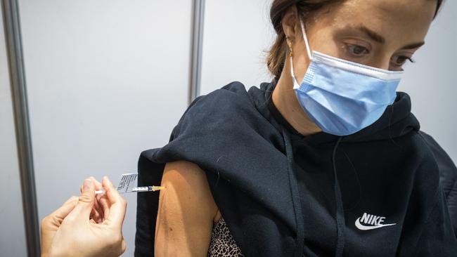 A woman receives the Pfizer vaccine at the Royal Exhibition Building in Melbourne. Picture: Getty