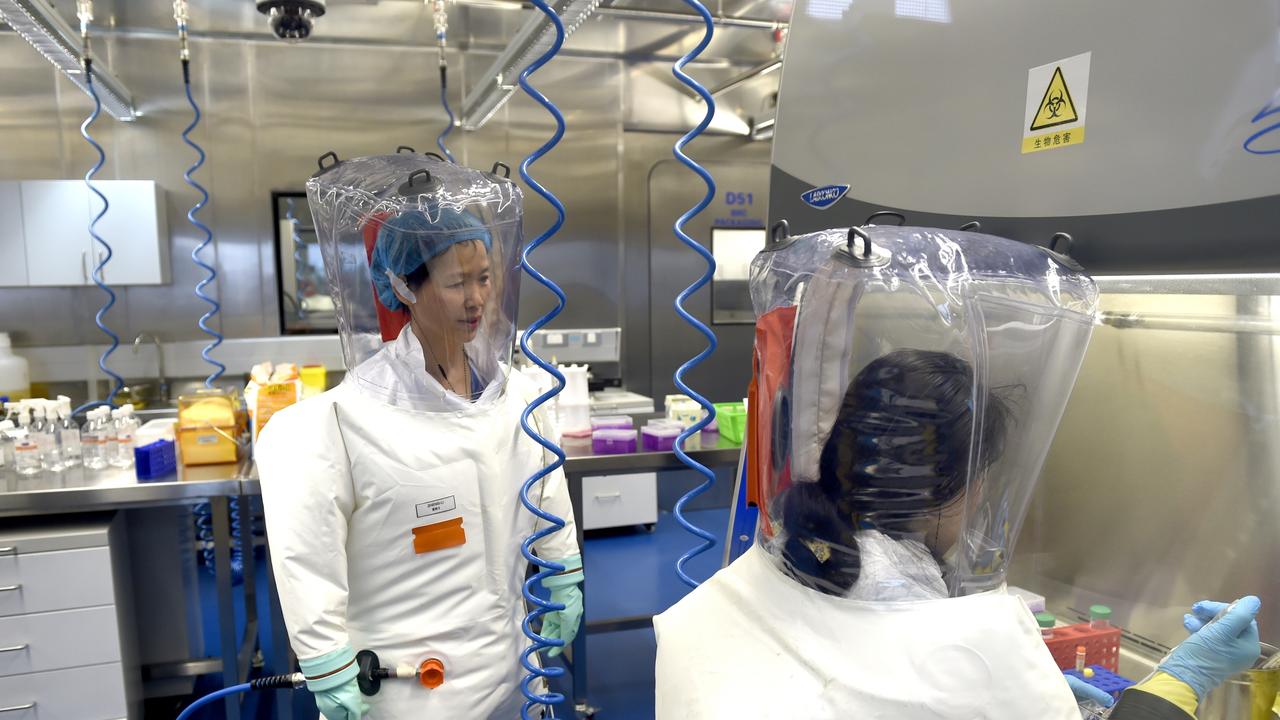 Virologist Shi Zheng-li, left, works with her colleague in the P4 lab of Wuhan Institute of Virology in February 2017. Picture: Feature China/Barcroft Media via Getty Images.