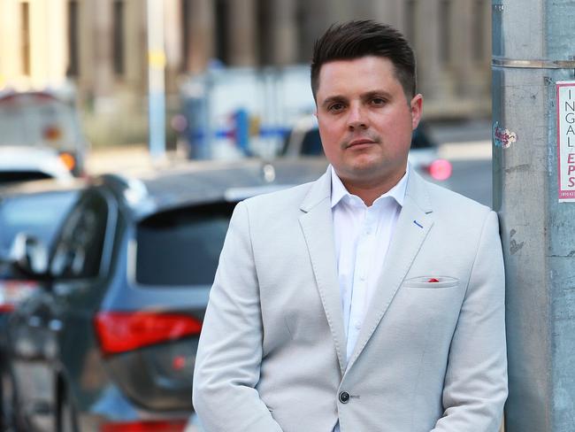 Dominic Holland CEO and Managing Director of Tow.com.au poses on Queen Street in Brisbane on Monday, October 9, 2017. Mr Holland has filed a $15.4 million lawsuit against the Queensland Government in the Supreme Court. (AAP Image/Claudia Baxter)