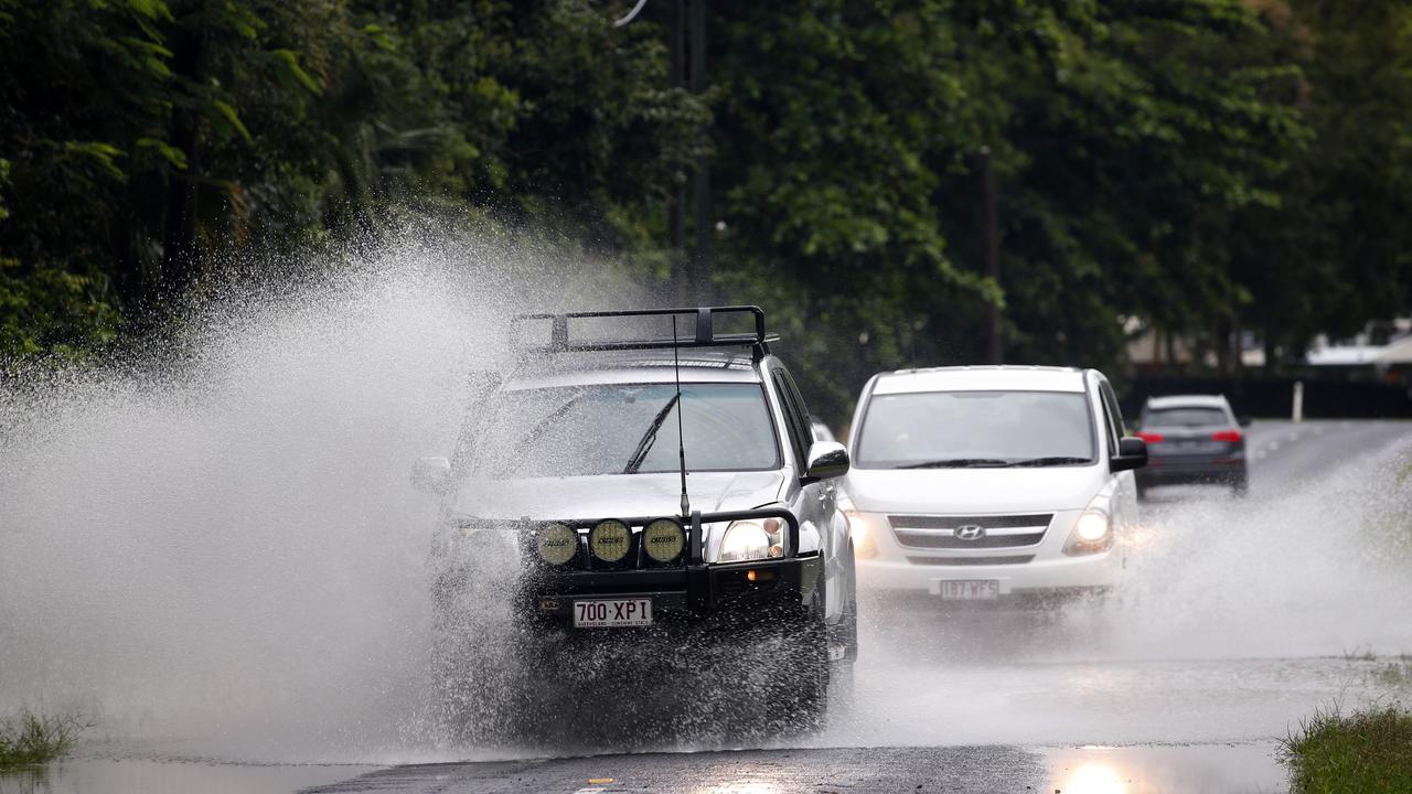 Cars drive through water on Lower Freshwater Rd in Kamerunga after the rain overnight in Cairns PICTURE: ANNA ROGERS