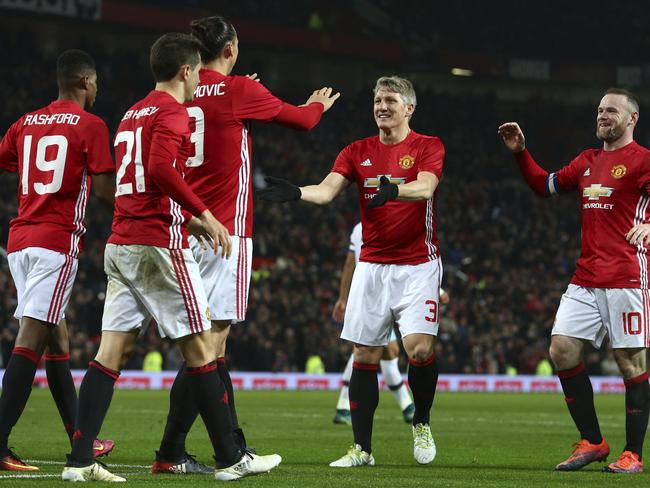 Manchester United's Zlatan Ibrahimovic, third left is congratulated by teammates.