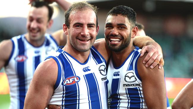 Ben Cunnington and Tarryn Thomas celebrate after North downed Hawthorn. Picture: Steve Bell/Getty Images