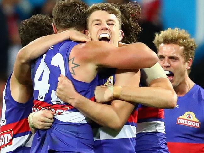 SYDNEY, AUSTRALIA - JULY 02: Jack Macrae of the Bulldogs and team mates celebrate winning the round 15 AFL match between the Sydney Swans and the Western Bulldogs at Sydney Cricket Ground on July 2, 2016 in Sydney, Australia. (Photo by Cameron Spencer/Getty Images)