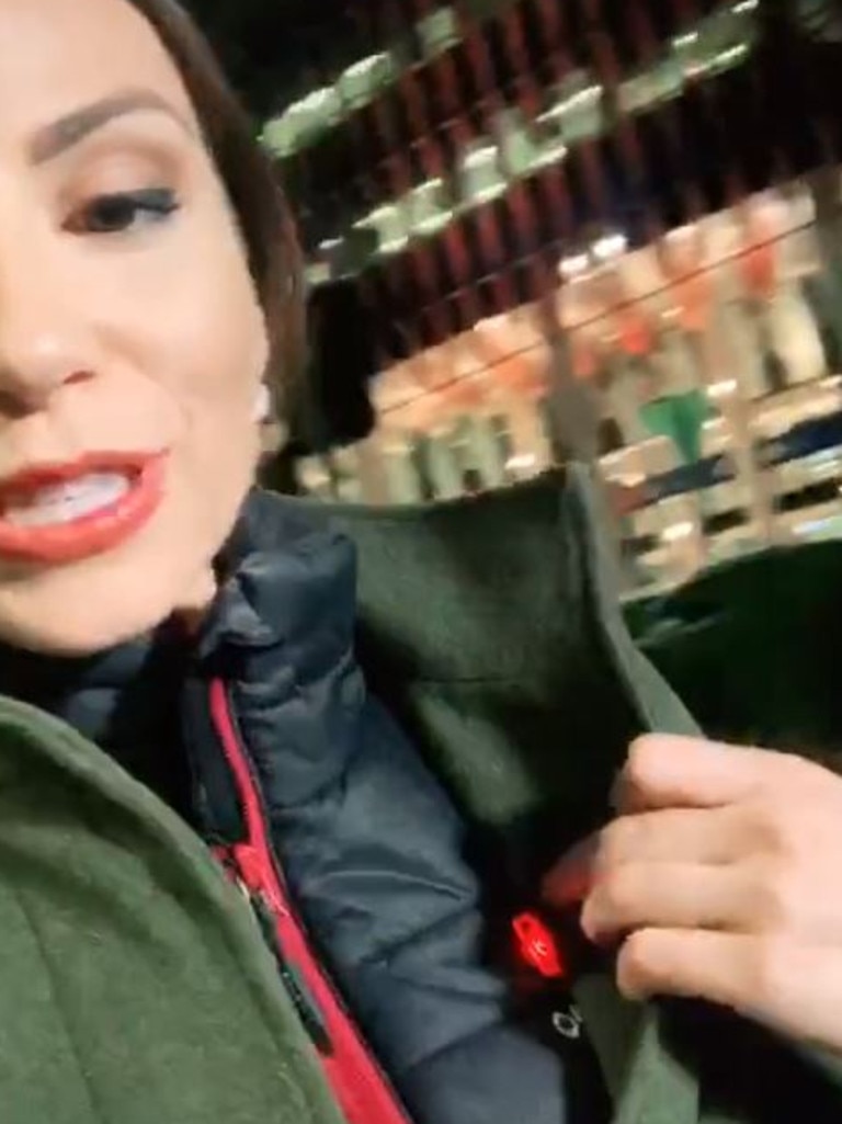 She pulled back her jacket to reveal a hidden gadget underneath. Picture: TikTok/Kristina Costalos
