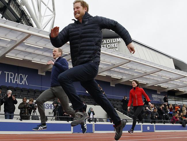 Catch him if you can - Prince Harry pulls away from his brother and sister-in-law. Picture: AP Photo/Alastair Grant