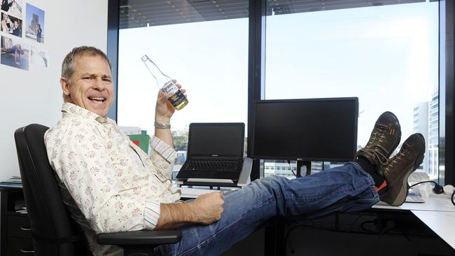 Michael Dempsey relaxes and celebrates at his Newstead office after selling his Ezidebit payment company to Global Payments for AUD $305m. Photo: Claudia Baxter