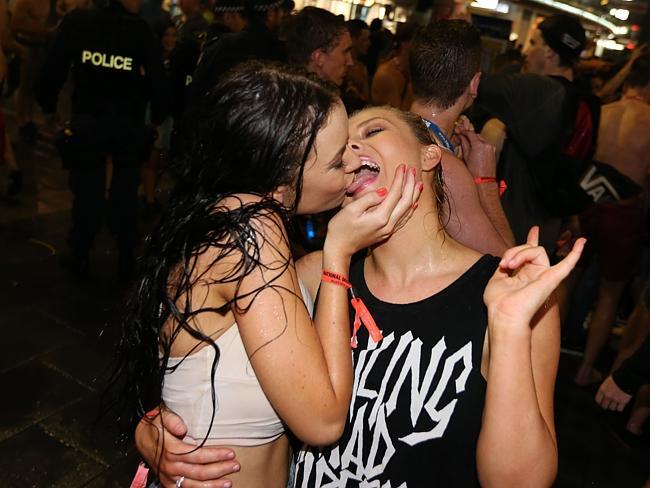 2 girls embrace School leavers party hard as a storm hits on Caville Ave on Saturday night in Surfers Paradise. Pic: Lindsay Moller