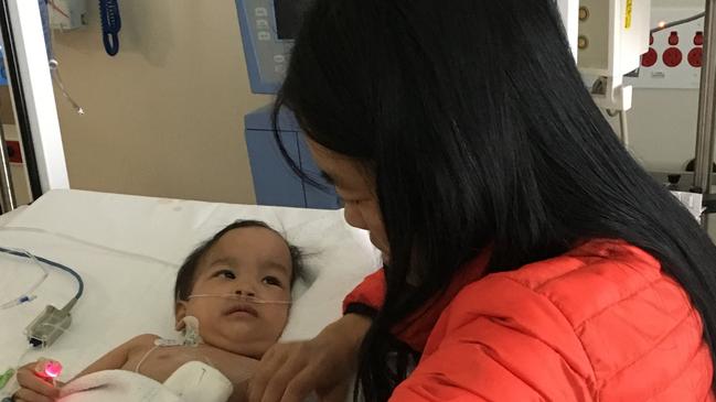 Dawa Pelden lies on her back for the first time as she recovers from separation surgery with her mum, Bhumchu Zangmo, by her side.