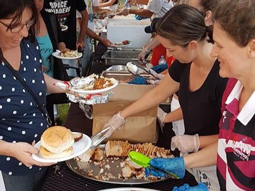 Agape Outreach volunteers serve up meals.