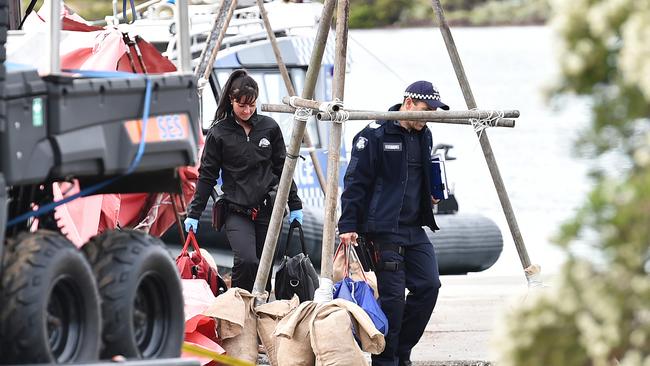 Police recover debris from the crashed plane. Picture: Nigel Hallett