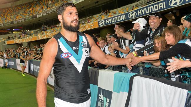 Paddy Ryder acknowledges the fans after a Port Adelaide win over Brisbane at the Gabba. Picture: Bradley Kanaris/Getty Images