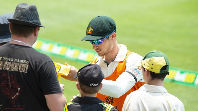 Cameron Bancroft signs autographs for fans on Day 1 of the test match between Australia and Pakistan at the Gabba. Photo Lachie Millard