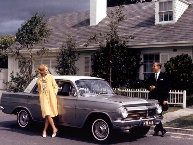 1960s mannequins pose with a 1964 EH Holden motor car outside suburban house. Picture: Supplied