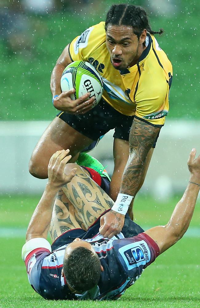 Joe Tomane of the Brumbies breaks through a tackle.