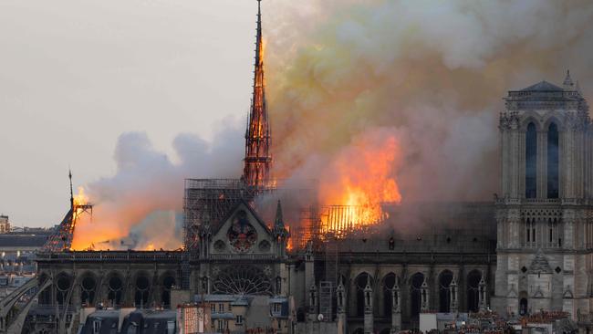 Flames and smoke engulf the spire and roof of the gothic cathedral, visited by millions of people a year. Picture: Fabien Barrau/AFP