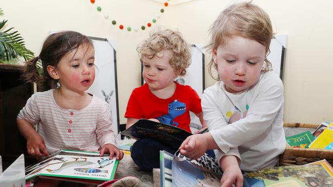 Toddlers reading books together. Picture: David Crosling