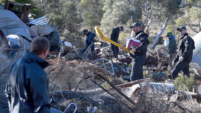 Police officers search the Oulnina Park rubbish dump and fire pit. Picture: Naomi Jellicoe