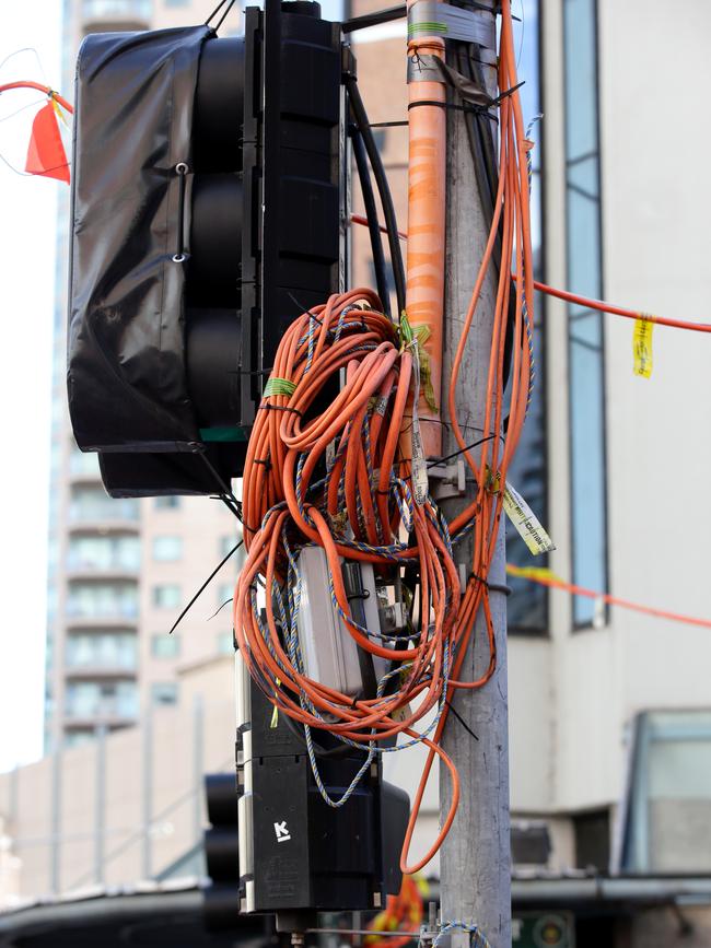 Temporary wires hanging on a traffic light near where the incident happened. Picture: Jonathan Ng