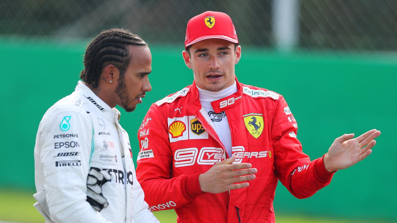 Pole position qualifier Charles Leclerc (R) talks with second place qualifier Lewis Hamilton at Monza.