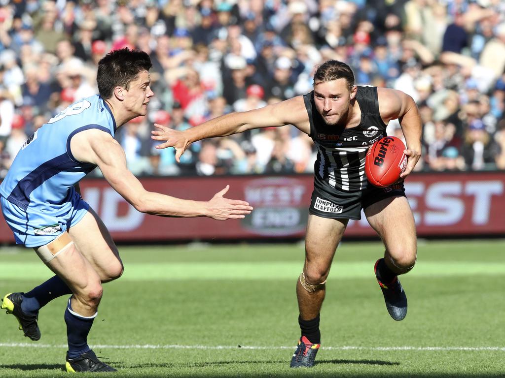 Thomas Gray fends off Jack Stephens. Picture Sarah Reed