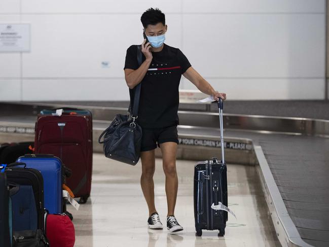 People from Sydney collecting their bag after police check at Brisbane Domestic Airport, Brisbane, 21st of December 2020. (News Corp/Attila Csaszar)