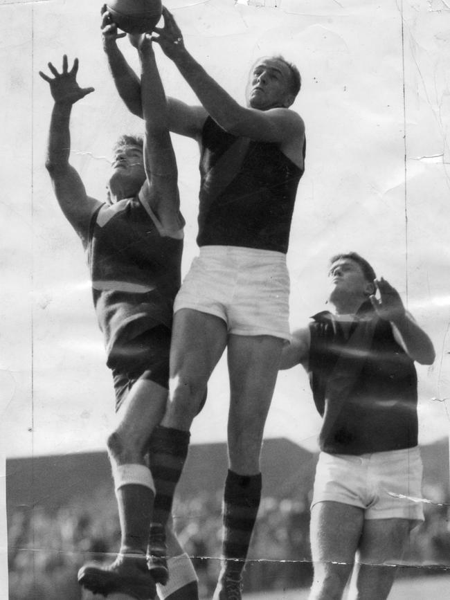 Gun tennis player and footballer Ken McGregor, pictured flying for a mark in 1958.