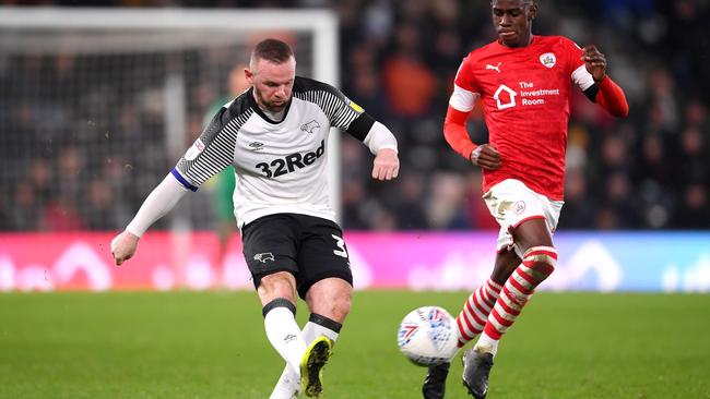 Derby County captain Wayne Rooney passes the ball while under pressure from Elliot Simoes of Barnsley at Pride Park Stadium. Picture: Getty Images