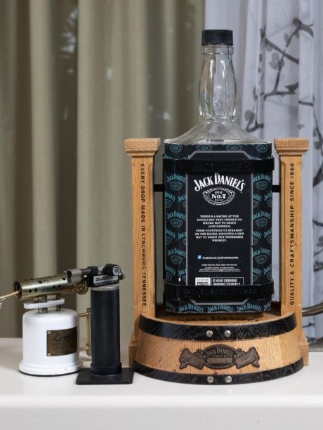 For sale is an empty Jack Daniels swing bottle and corkscrew