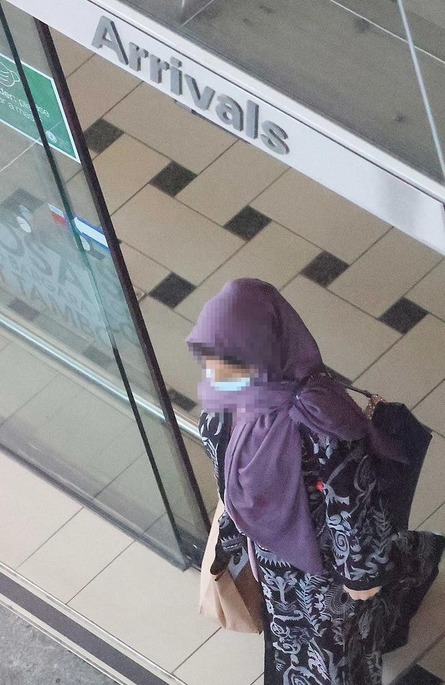 A woman leaves the arrivals area at Brisbane International Airport after arriving from Afghanistan. Picture: Liam Kidston.