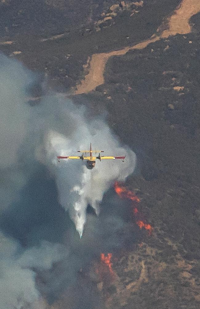 Aerial firefighting aircraft drop water on the Hughes Fire in Castaic, a neighborhood of Los Angeles, California. Picture: AFP