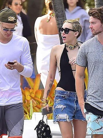 Miley Cyrus with Cody Simpson, on left, and Patrick Schwarzenegger. Picture: Splash