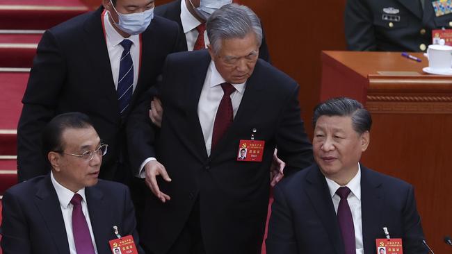 Former Chinese President Hu Jintao (centre) being escorted out of a Communist Party meeting. Getty Images