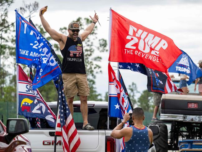 Supporters of US President-elect Donald Trump gether with hundreds of decorated cars and trucks during a Trump Victory Parade in West Palm Beach, Florida, on November 17, 2024. (Photo by Jim WATSON / AFP)