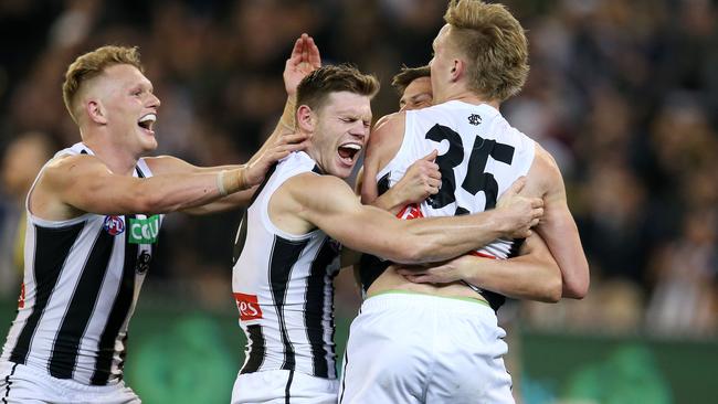 Collingwood players swamp Jaidyn Stephenson after he booted a preliminary final goal. Pic: Michael Klein