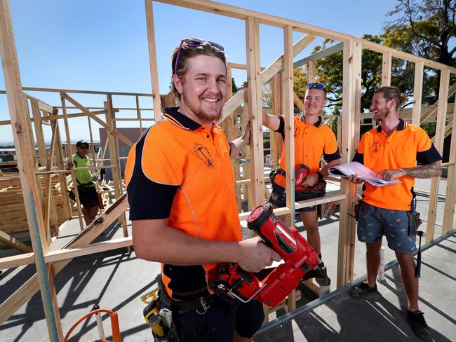 TAFE carpentry apprentices Ethan Sutherland and Karl Van Rijssen with apprentice manager Steve Purcell working on a 54-townhouse development at Richlands. Picture: Tara Croser.