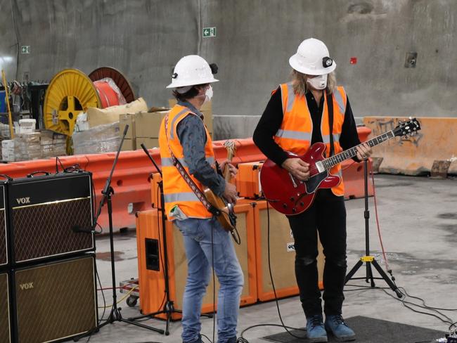 Powderfinger guitarists Darren Middleton and Ian Haug perform below Brisbane's CBD. Picture: Cross River Rail