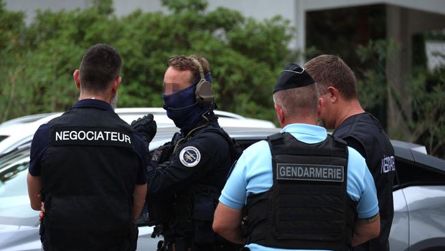 Special forces negotiators flanked by a French gendarme officer of the elite police tactical unit at the scene of the attack. Picture: AFP