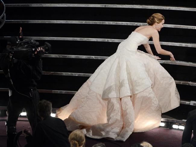 Jennifer Lawrence trips over the stairs on her way to pick up her Best Actress gong at the Academy Awards in February. Picture: Getty