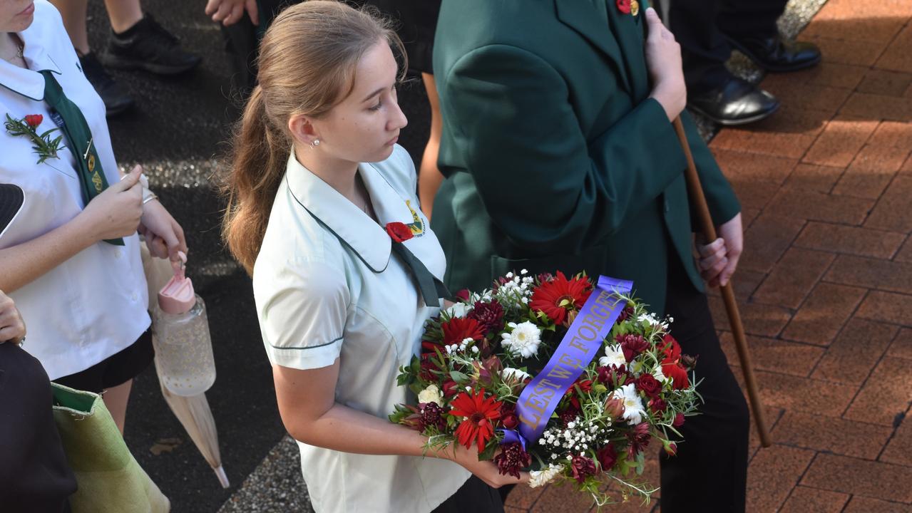 A student carries a wreath in the parade.