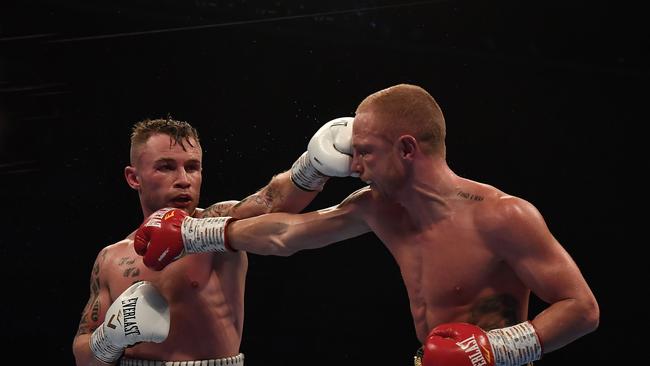 Carl Frampton, left, lands a jab on Tasmania’s Luke Jackson in the WBO featherweight world title fight in Belfast, Northern Ireland. Picture: GETTY IMAGES