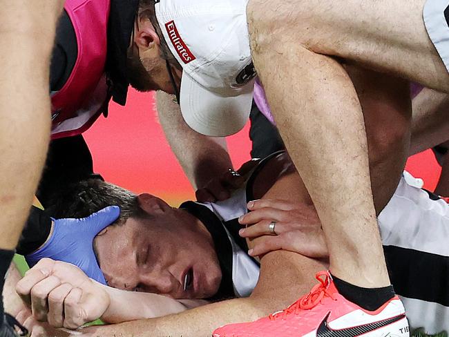 AFL Round 12....15/08/2020.... Melbourne vs Collingwood at the Gabba, Brisbane.  Brody Mihocek of the Magpies lies on the ground in the hands of trainers and the doctor after he collided with Aaron vandenBerg of the Demons q2  . Pic: Michael Klein