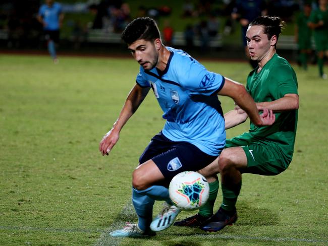 Sydney FC v FNQ Select XI @ Barlow Park. Sydney's Paulo Retre and FNQ's Anthony Caceres. PICTURE: STEWART MCLEAN