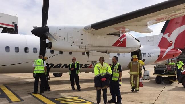 The aircraft landed at Sydney Airport with smoke coming from the left-hand side of the wheel. Picture: Charles Miranda