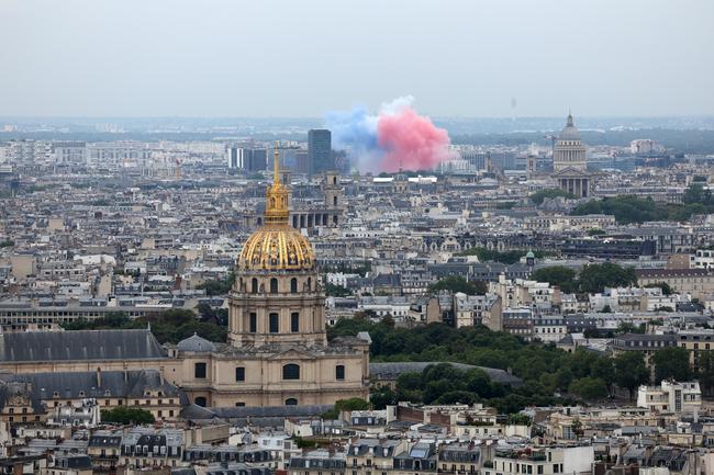 PARIS, FRANCE - JULY 26: A general view over the city of Paris as Smoke resembling the flag of Team France is seen indicating the start of the opening ceremony of the Olympic Games Paris 2024 on July 26, 2024 in Paris, France. (Photo by Ezra Shaw/Getty Images)