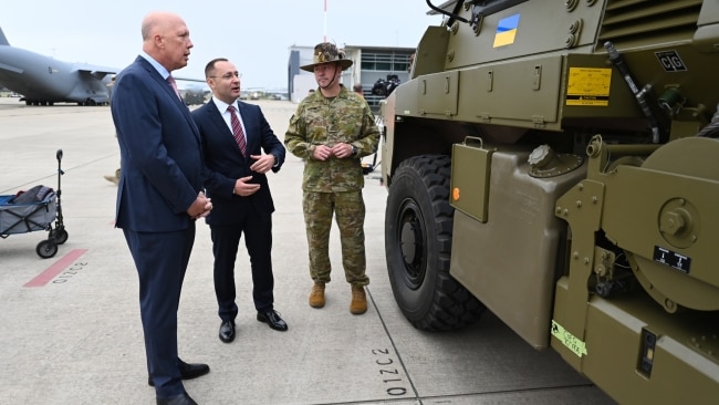 Ukrainian Ambassador to Australia Vasyl Myroshnychenko (centre) and Defence Minister Peter Dutton (left) inspect a Bushmaster PMV Armoured Vehicle at the Amberley Air Base Ipswich. Picture: Getty Images